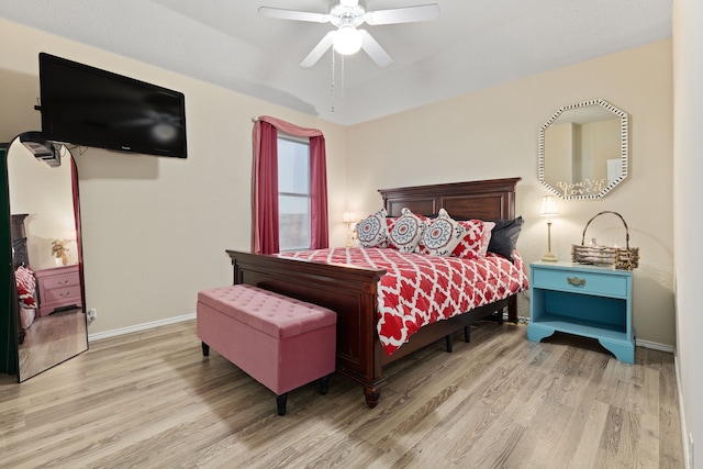 bedroom with ceiling fan and light hardwood / wood-style flooring