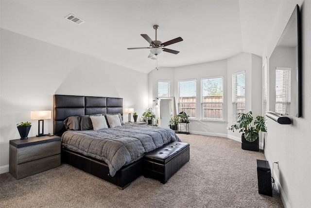 carpeted bedroom with vaulted ceiling and ceiling fan