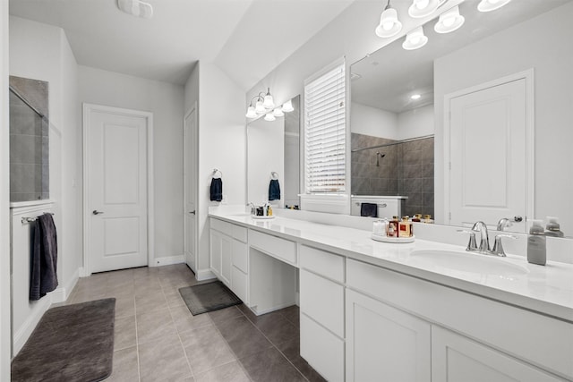 bathroom with tile patterned floors, vanity, and tiled shower