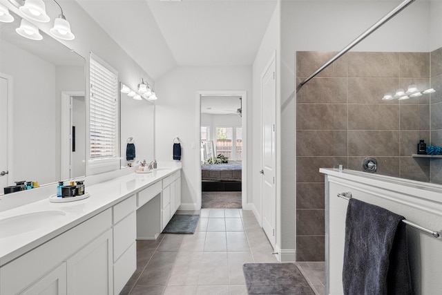 bathroom featuring ceiling fan, tile patterned floors, lofted ceiling, tiled shower, and vanity