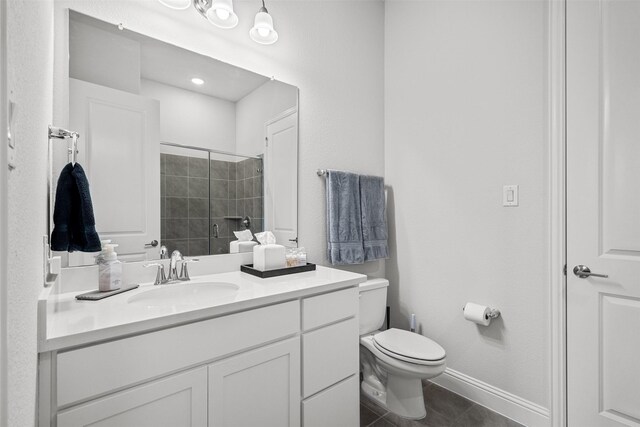 bathroom with tile patterned floors, vanity, toilet, and walk in shower