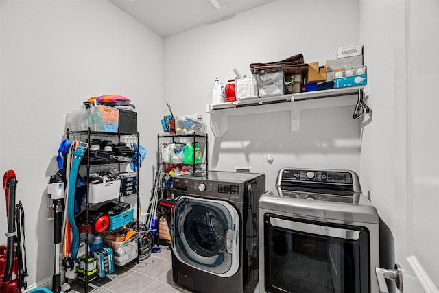 laundry room featuring washing machine and clothes dryer and light tile patterned floors