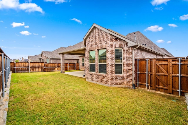 back of property featuring a lawn and a patio