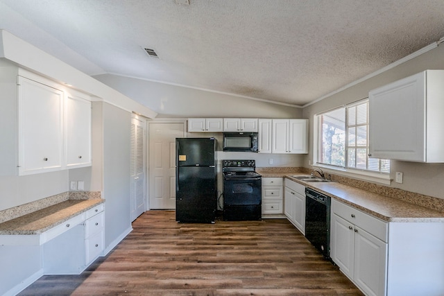 kitchen featuring black appliances, dark hardwood / wood-style flooring, white cabinetry, and vaulted ceiling