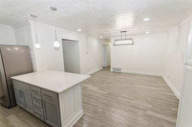 interior space with pendant lighting, stainless steel fridge, gray cabinetry, and light hardwood / wood-style floors