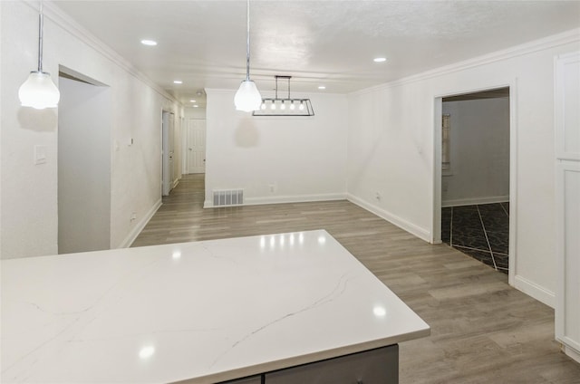 unfurnished dining area featuring crown molding and light hardwood / wood-style floors