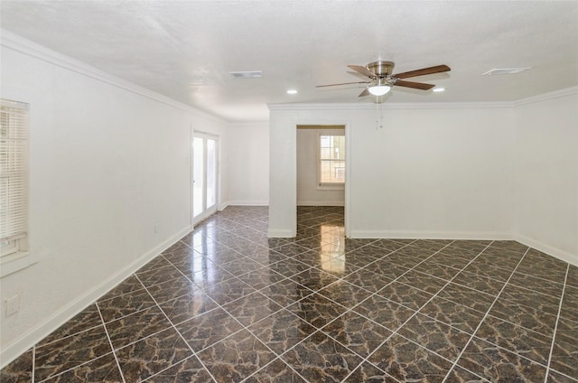 empty room with marble finish floor, ornamental molding, visible vents, and baseboards