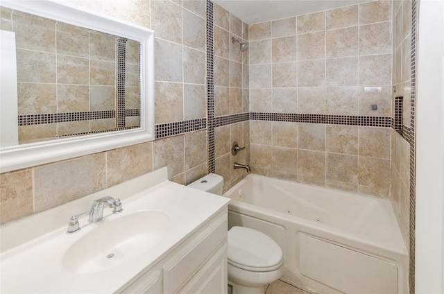 bathroom with washtub / shower combination, tile walls, vanity, and toilet