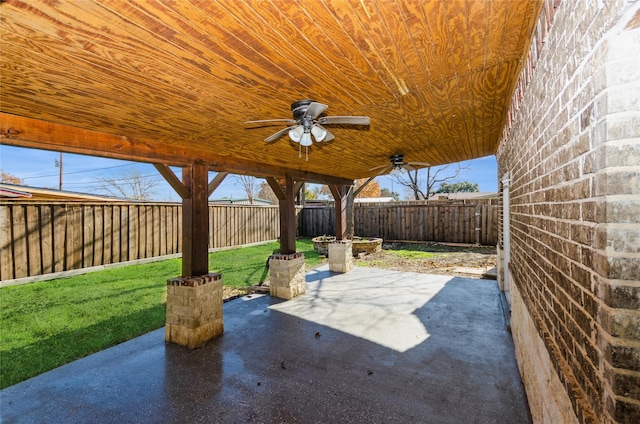 view of patio with a fenced backyard and ceiling fan