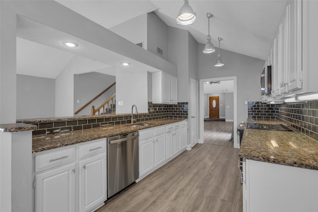 kitchen featuring white cabinets, a textured ceiling, and stainless steel appliances