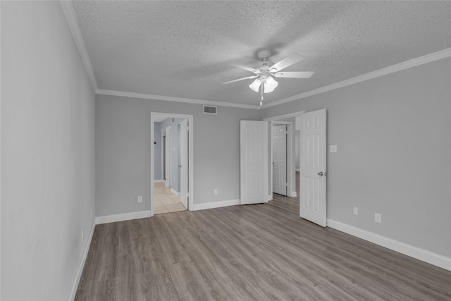 empty room with crown molding, ceiling fan, a textured ceiling, and light wood-type flooring