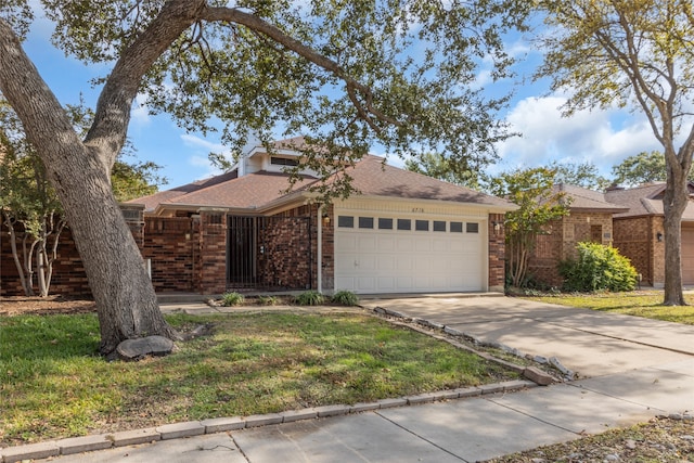 single story home with a garage and a front yard