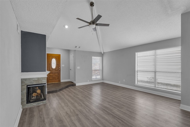 unfurnished living room with hardwood / wood-style flooring, ceiling fan, and a textured ceiling