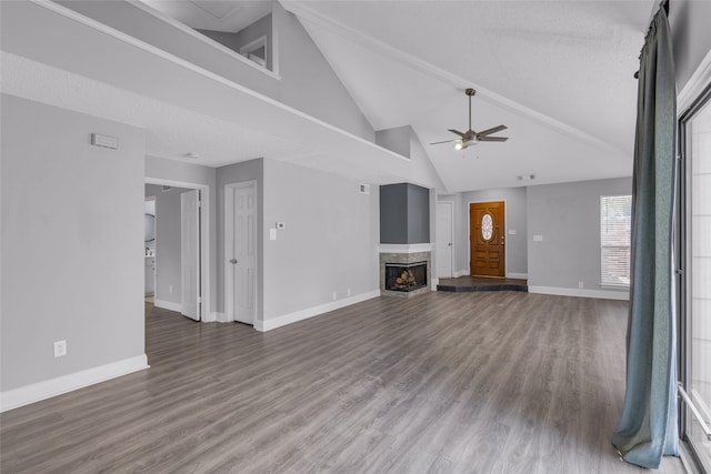 unfurnished living room with a textured ceiling, ceiling fan, high vaulted ceiling, a multi sided fireplace, and hardwood / wood-style floors