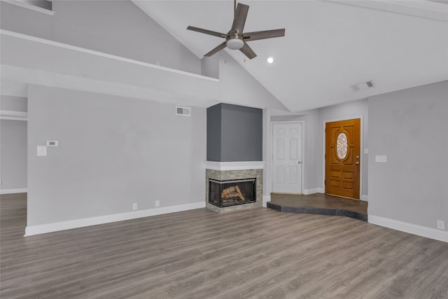 unfurnished living room featuring a multi sided fireplace, wood-type flooring, high vaulted ceiling, and ceiling fan