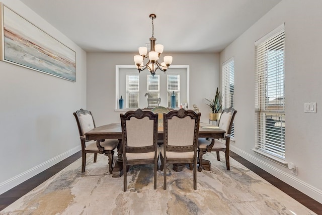 dining space with an inviting chandelier, hardwood / wood-style floors, and plenty of natural light