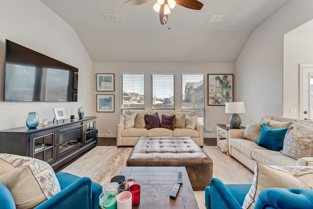 living room featuring ceiling fan, vaulted ceiling, and wood-type flooring