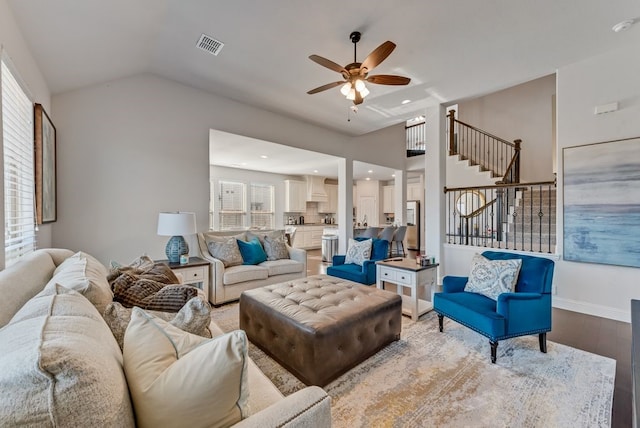 living room featuring ceiling fan, lofted ceiling, plenty of natural light, and light hardwood / wood-style floors