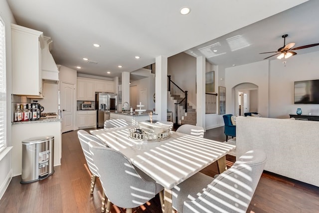 dining area featuring ceiling fan, dark hardwood / wood-style flooring, and sink