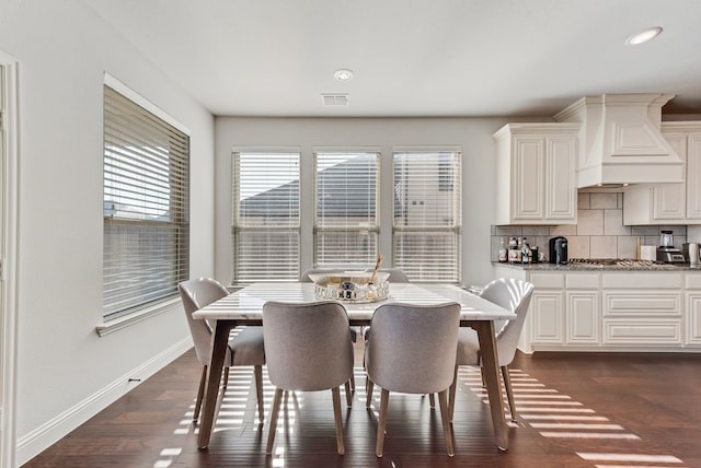 dining area with dark hardwood / wood-style floors