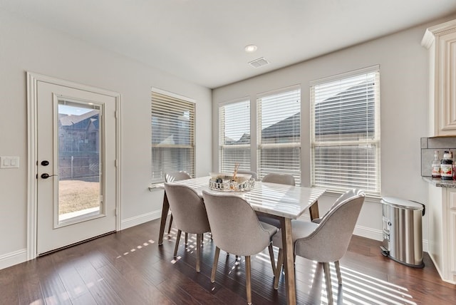 dining area featuring dark wood-type flooring