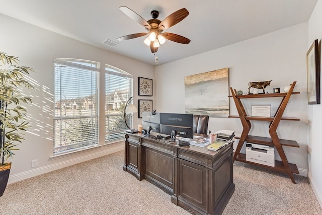 carpeted home office with ceiling fan