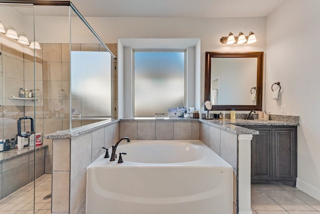 bathroom with tile patterned floors, vanity, and separate shower and tub