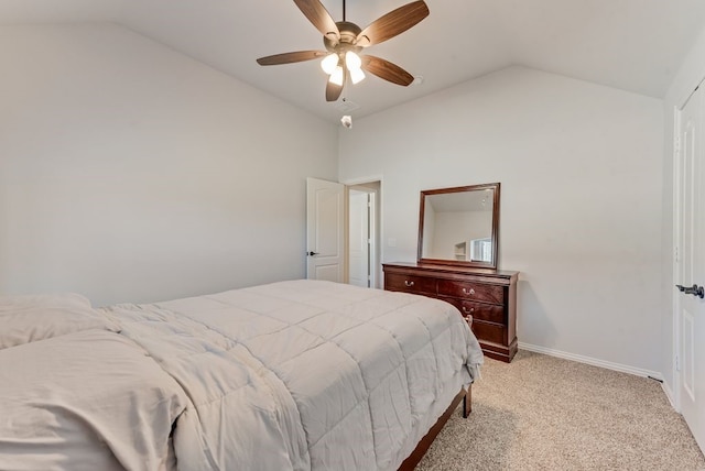 bedroom with vaulted ceiling, light colored carpet, and ceiling fan