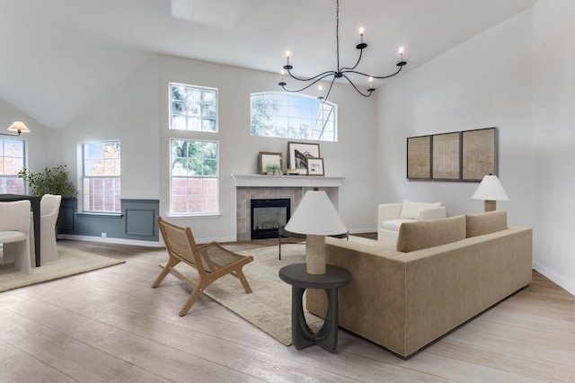 living room with plenty of natural light, light hardwood / wood-style floors, and a tile fireplace