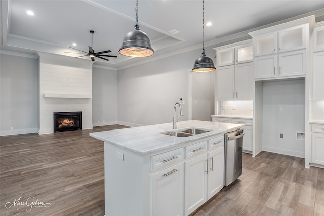 kitchen with sink, dishwasher, white cabinetry, light stone countertops, and decorative light fixtures