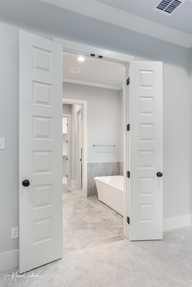 bathroom featuring a washtub and ornamental molding