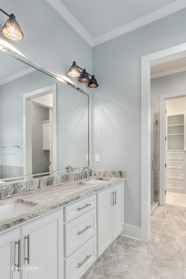 bathroom with vanity, an enclosed shower, and crown molding