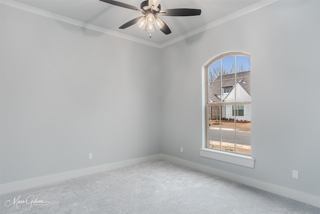 carpeted empty room featuring crown molding and ceiling fan