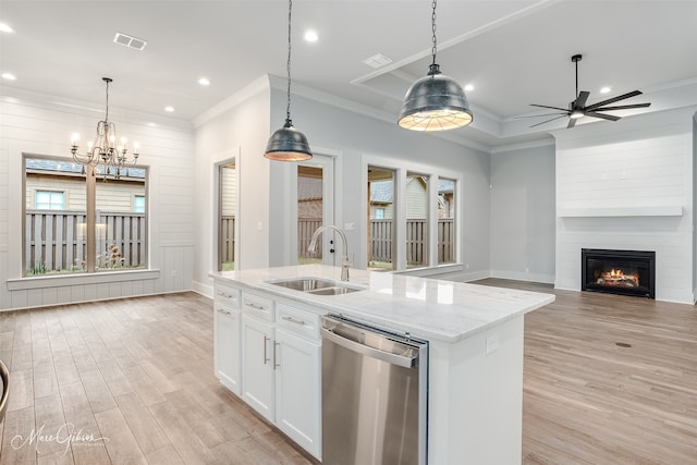 kitchen featuring pendant lighting, sink, dishwasher, light stone counters, and white cabinets