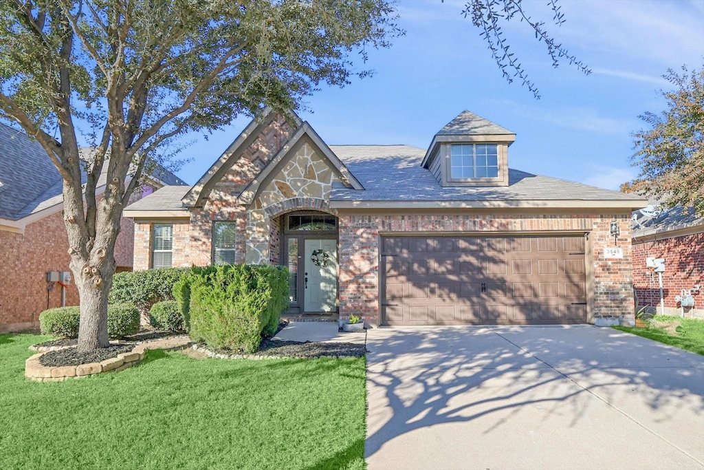 view of front of property with a garage and a front lawn