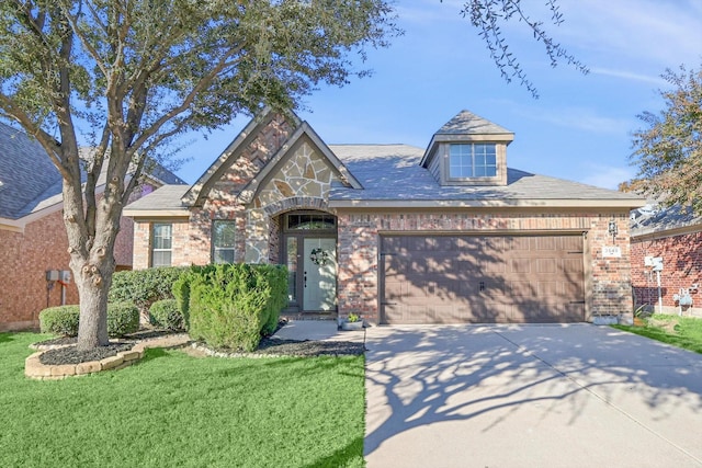 view of front of property with a garage and a front lawn