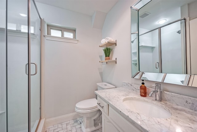 bathroom featuring an enclosed shower, vanity, and toilet