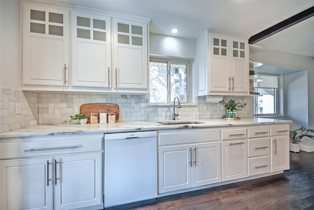 kitchen featuring decorative backsplash, white dishwasher, white cabinets, and sink