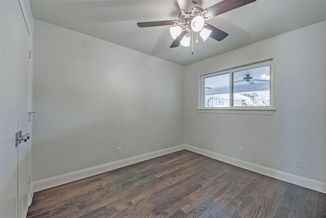 spare room with ceiling fan and dark wood-type flooring