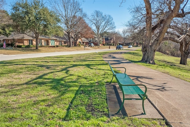 view of property's community with a lawn