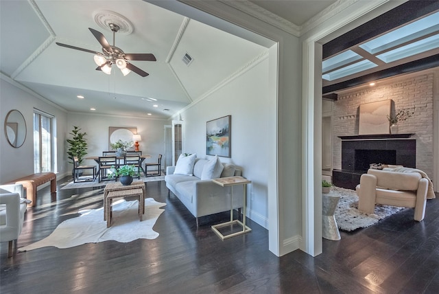 living room with vaulted ceiling, ceiling fan, ornamental molding, and dark hardwood / wood-style floors