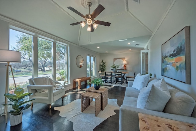 living room featuring ceiling fan, ornamental molding, and lofted ceiling