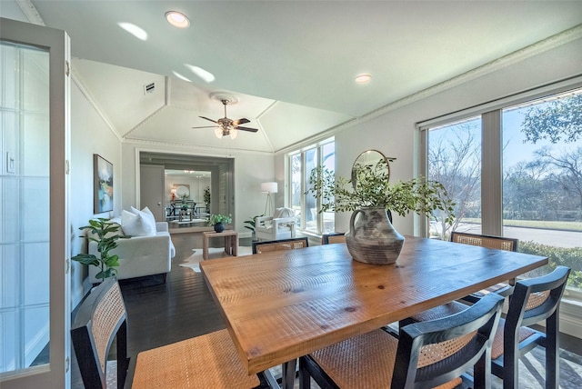 dining space featuring lofted ceiling, ceiling fan, ornamental molding, and hardwood / wood-style flooring