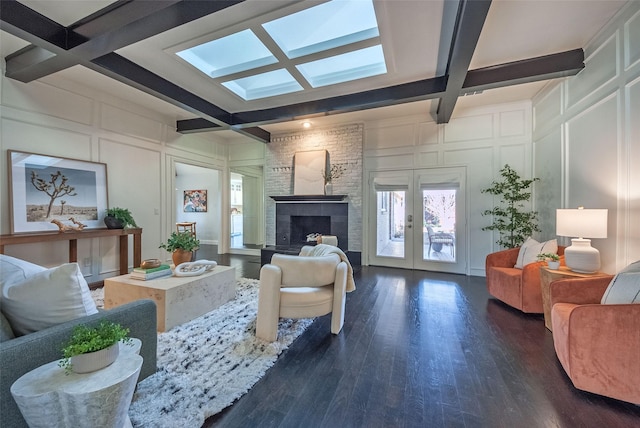 living room with dark hardwood / wood-style flooring, beam ceiling, french doors, and coffered ceiling