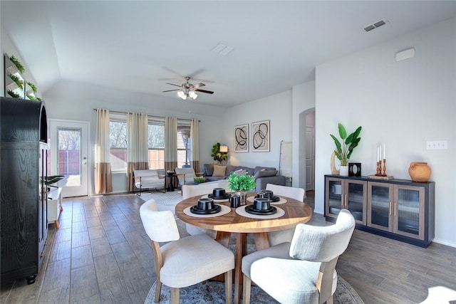 dining space featuring ceiling fan and dark wood-type flooring