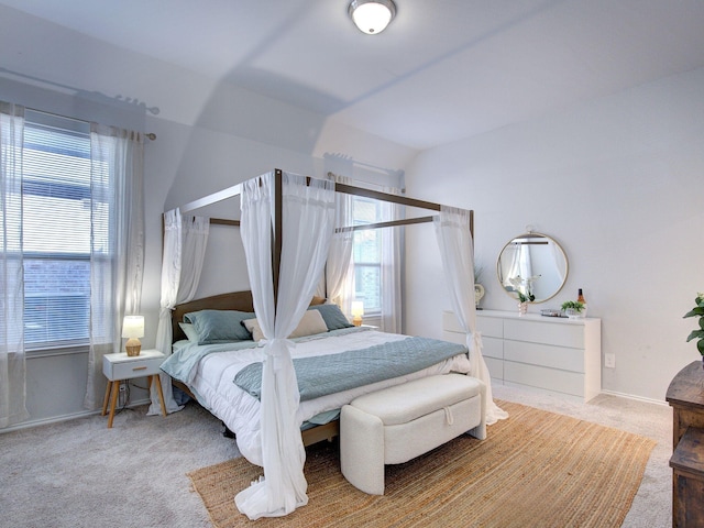 carpeted bedroom featuring vaulted ceiling