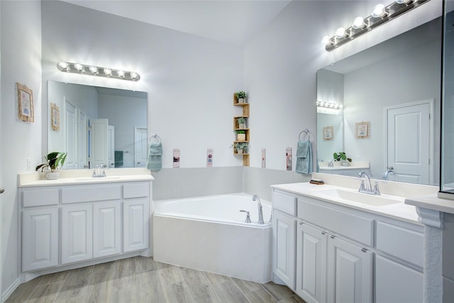 bathroom featuring a bath, vanity, and hardwood / wood-style flooring