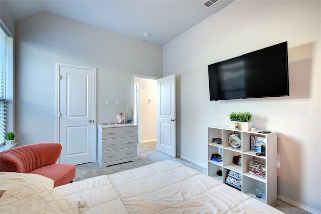 carpeted bedroom with lofted ceiling