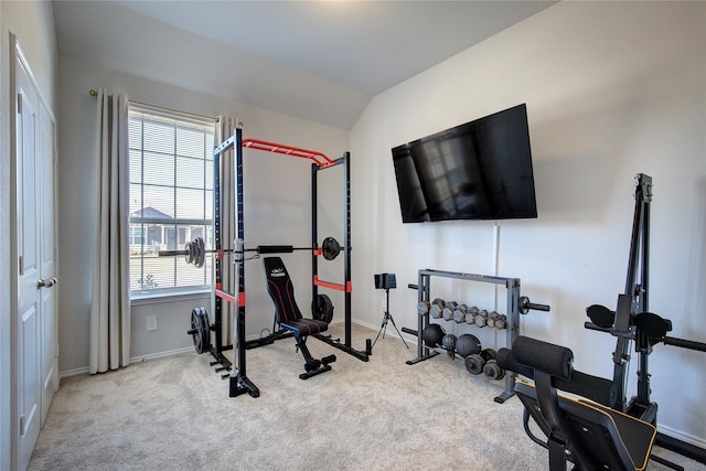 exercise room with plenty of natural light, light carpet, and vaulted ceiling