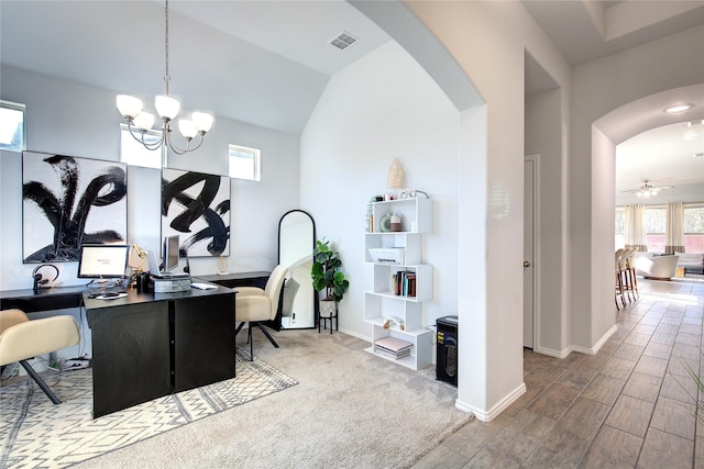 office space with hardwood / wood-style floors, ceiling fan with notable chandelier, and lofted ceiling